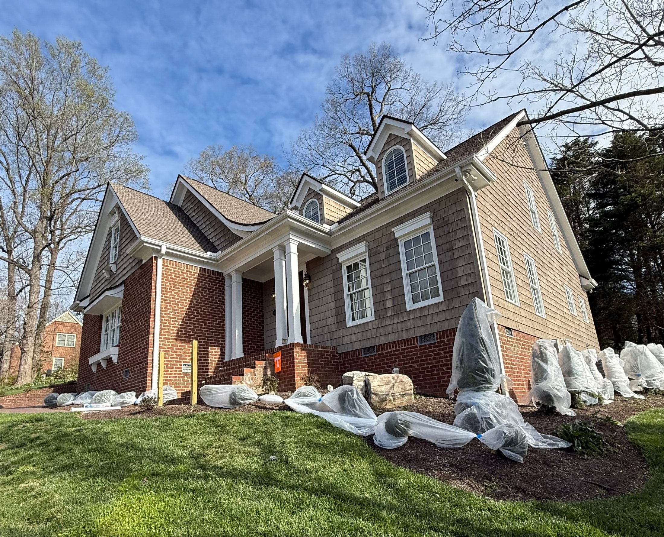 Shrubs wrapped before exterior painting on a Knoxville house