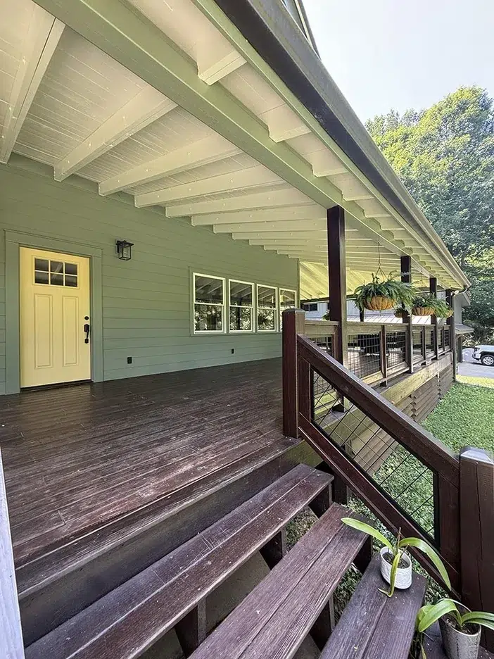 Deck staining Powell TN - dark stained porch deck boards, steps, and railing