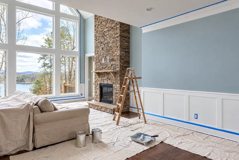Interior painting Tellico Village - lake-view living room with fresh gray-blue walls above taped wainscot