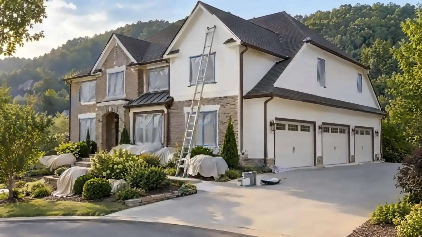 Brick-and-siding home with a three-car garage on a wooded hillside lot, painters in Powell, TN by Castle Painters